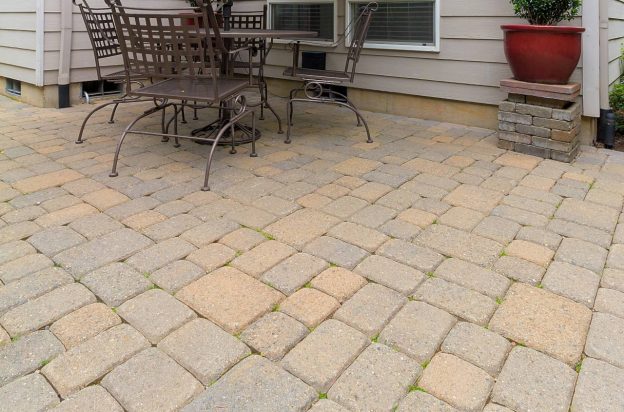 Newly installed paver patio with brown and tan tumbled pavers