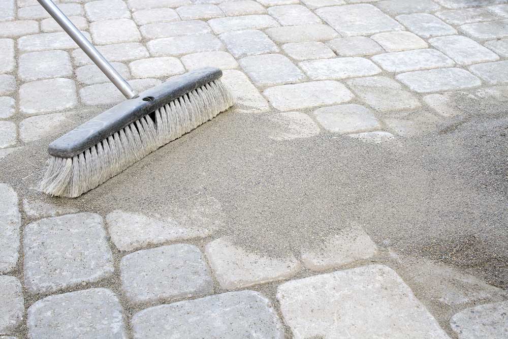 Add sand between the paver joints to lock the pavers together and prevent weeds