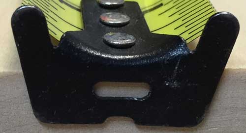 hook on a tape measure with a small slot or hole for hooking onto a nail  or screw to keep the hook from sliding off