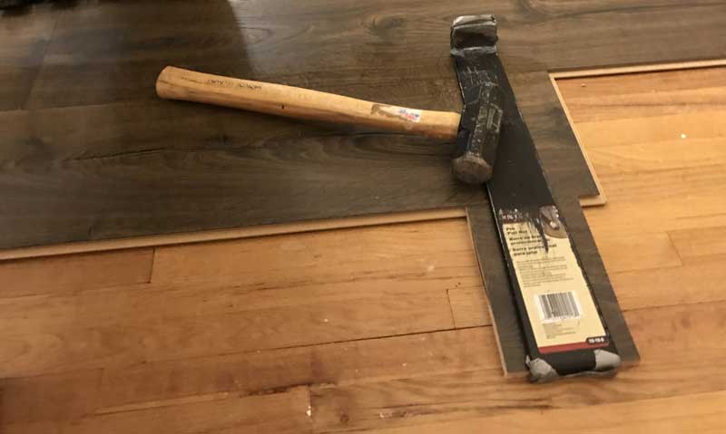 How To Install Laminate Flooring Inch Calculator Use A Pull Bar And Hammer To Tap Floor Into Place