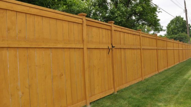 newly installed wooden privacy fence with gate