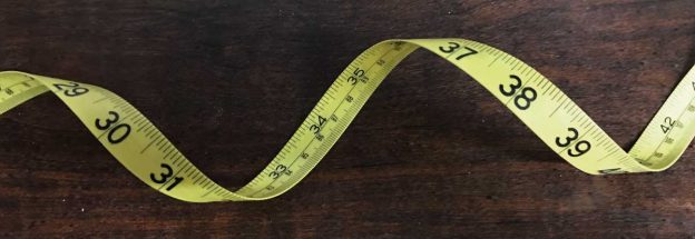 Flexible tape measure used to measure feet and inches