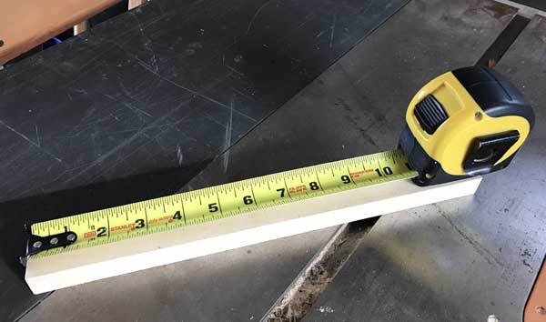 tape measure being used to measure a piece of wood