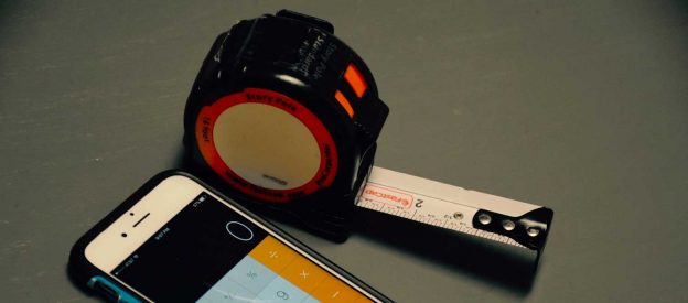 Tape measure and phone used to measure a room