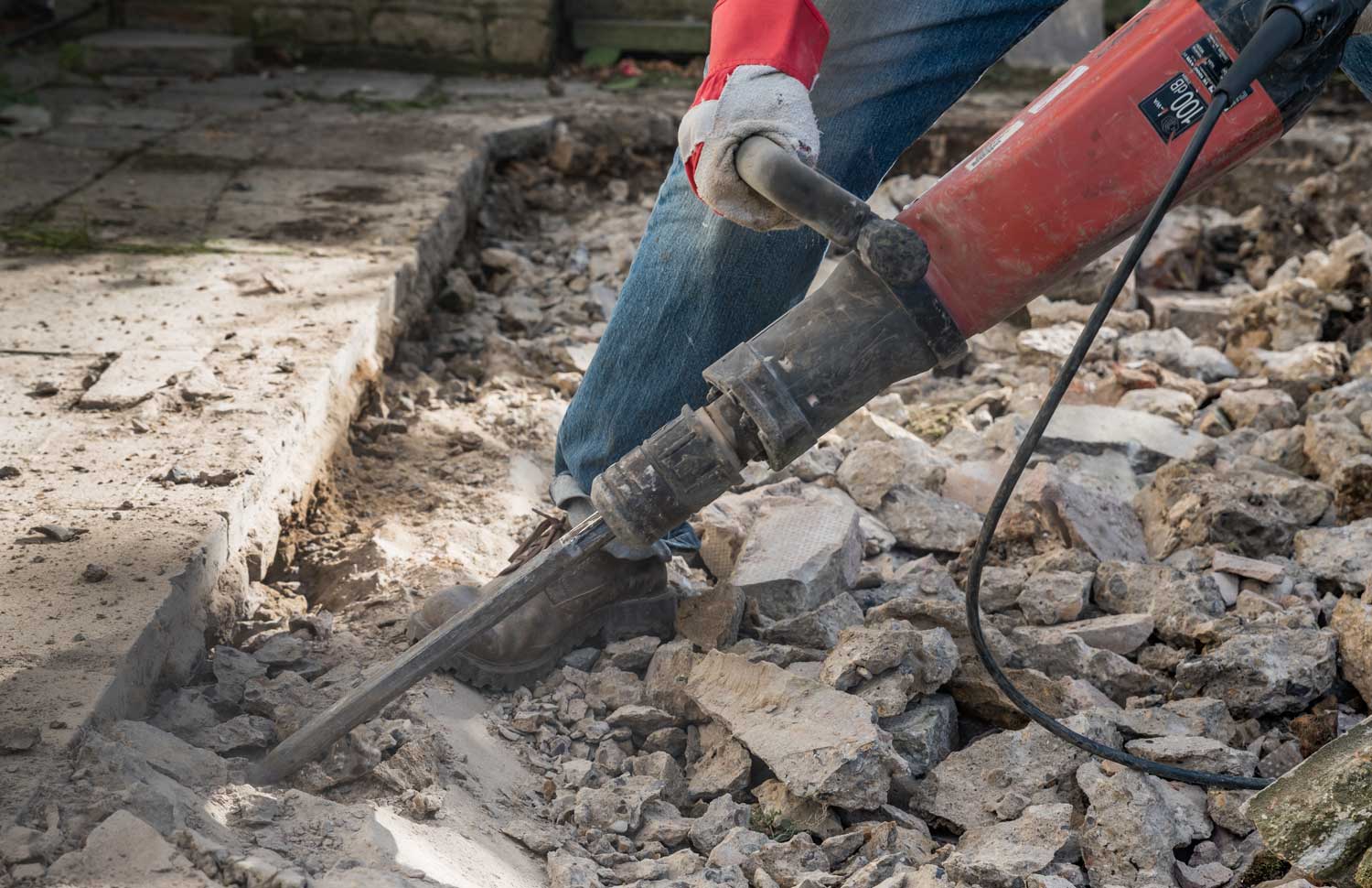 contractor demolishing and removing a concrete slab