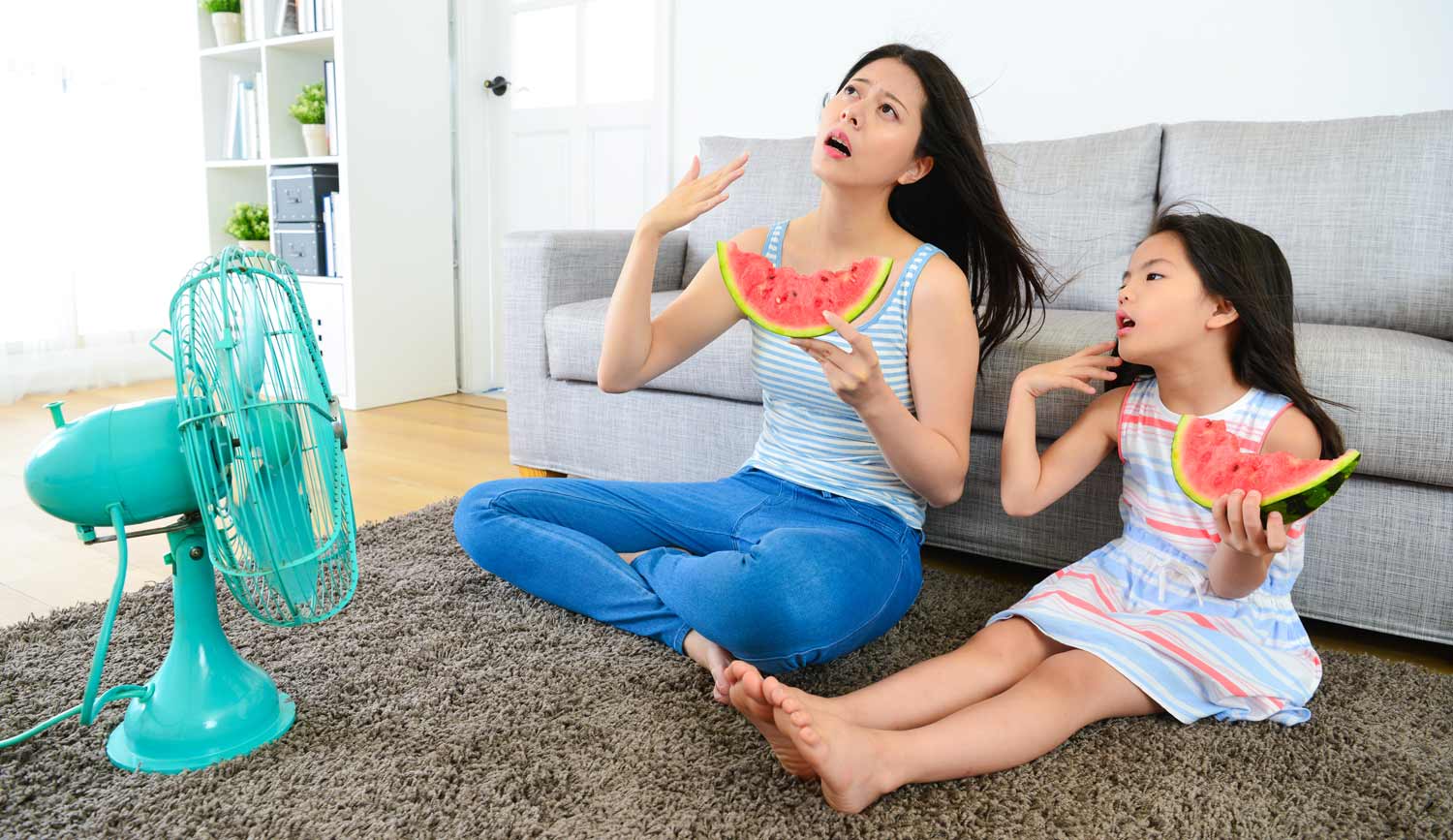 mother and daughter cooling off when AC is broken