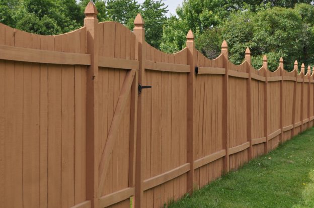 wooden fence installed along a property line