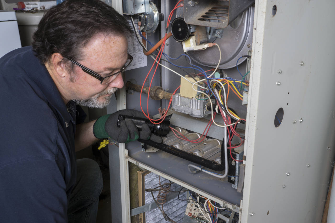 Technician repairing a natural gas furnace