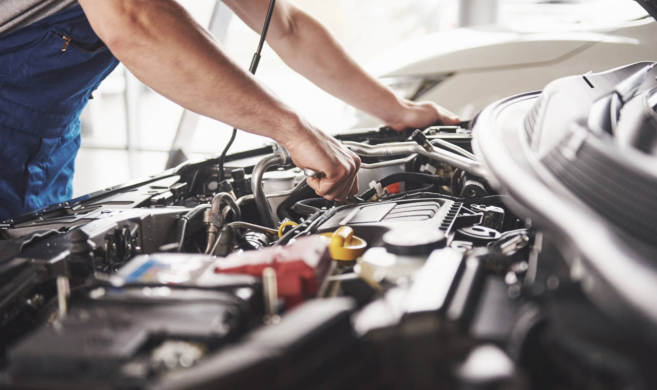 mechanic working on a car engine