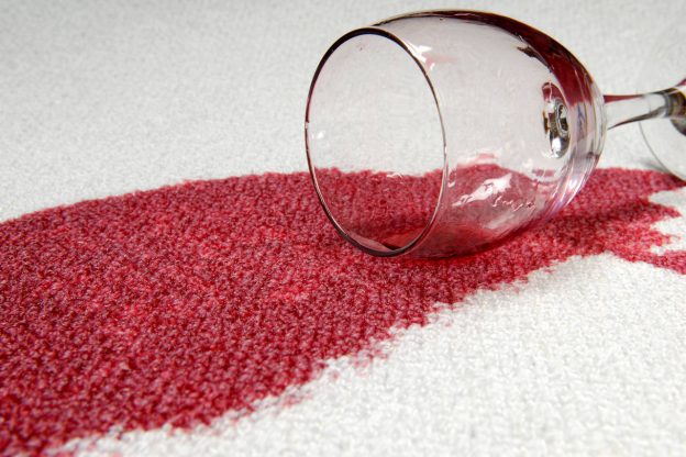 damaged carpet with a red wine stain