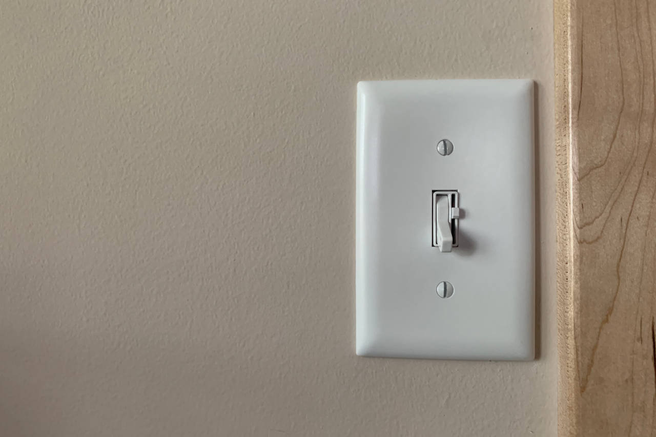 white light switch with a dimmer on a wall