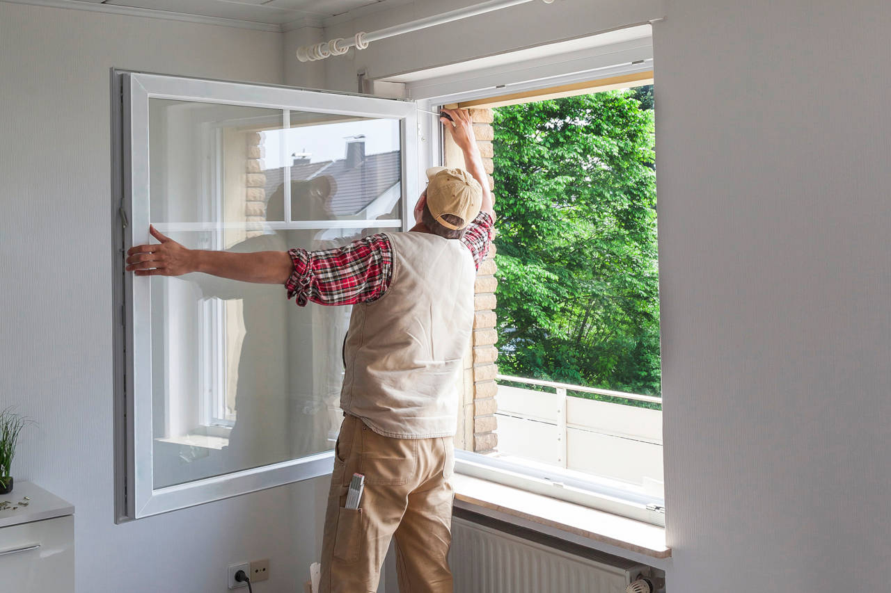 Contractor replacing a large casement window