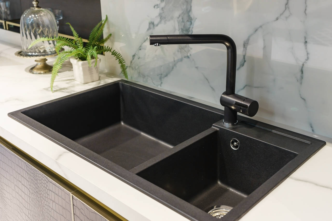 newly installed black enamel cast iron sink in a kitchen