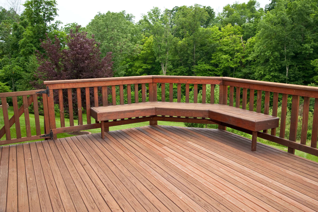 newly installed deck with redwood flooring and balusters