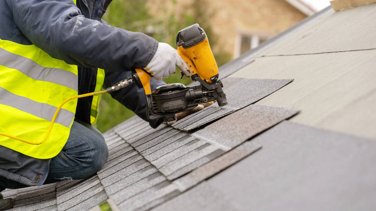 Roofing contractors install a new asphalt shingle roof