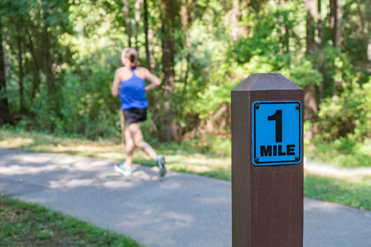 Runner passing the first mile marker