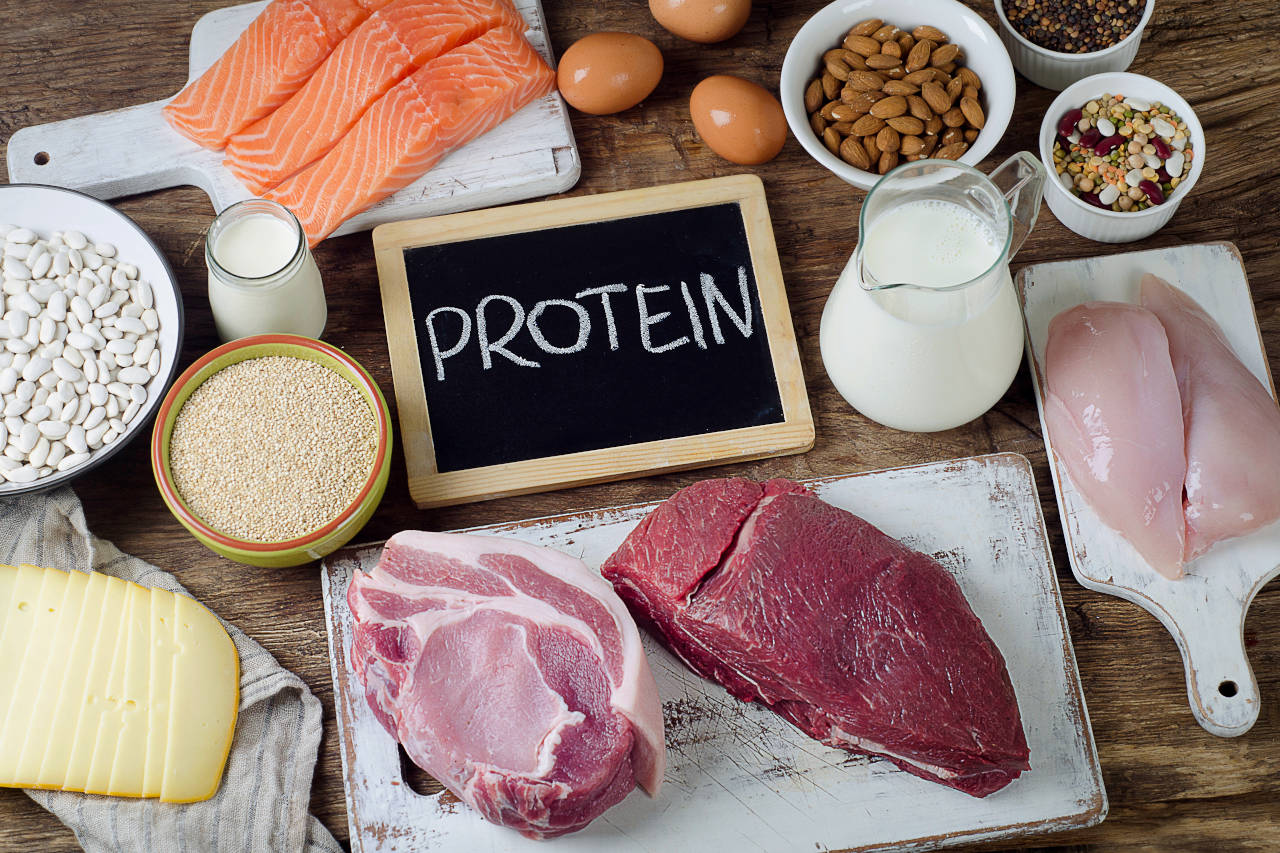 plate of foods that are high in protein, including lean red sirloin, chicken, salmon, and eggs
