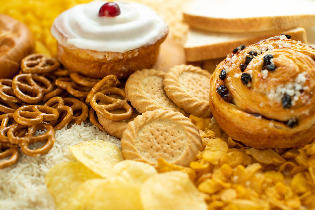 platter of foods high in simple carbohydrates, including pastries, cookies, high fructose corn syrup, and chips
