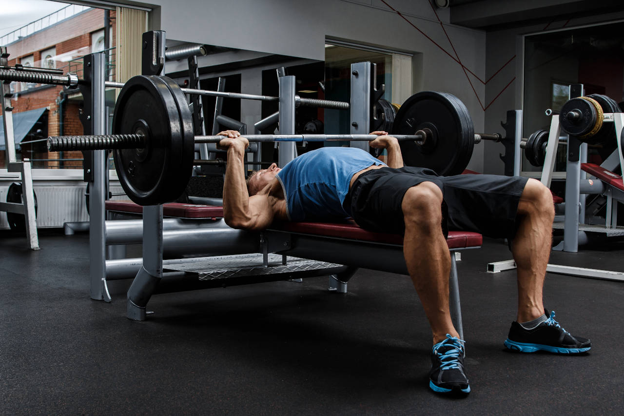 strength training athlete doing a one-rep max on the bench press